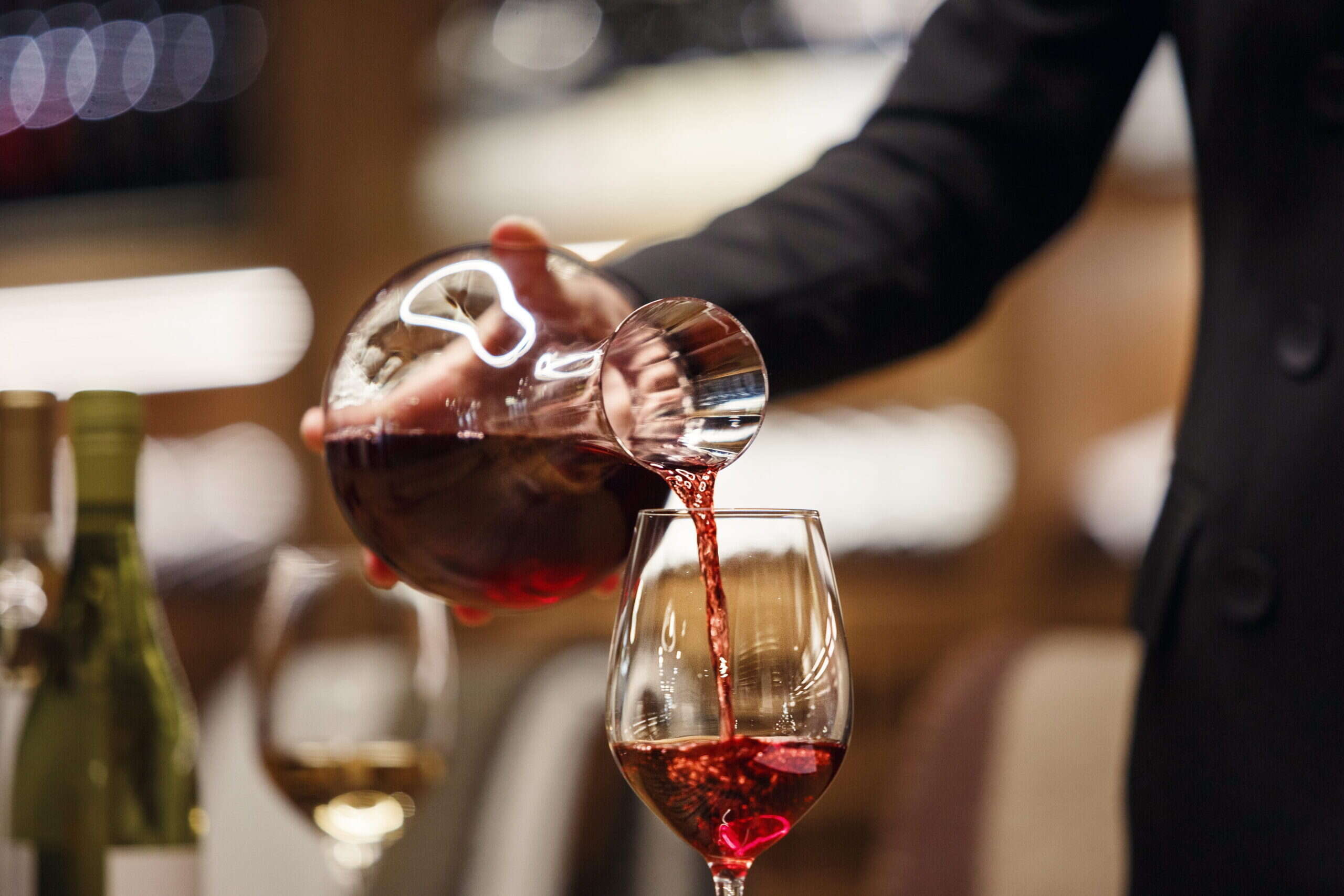wine being poured by sommelier
